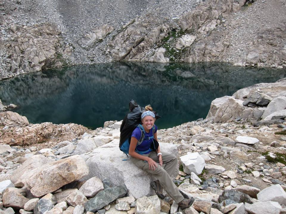 Girl in front of lake prior to hiking up Glen Pass