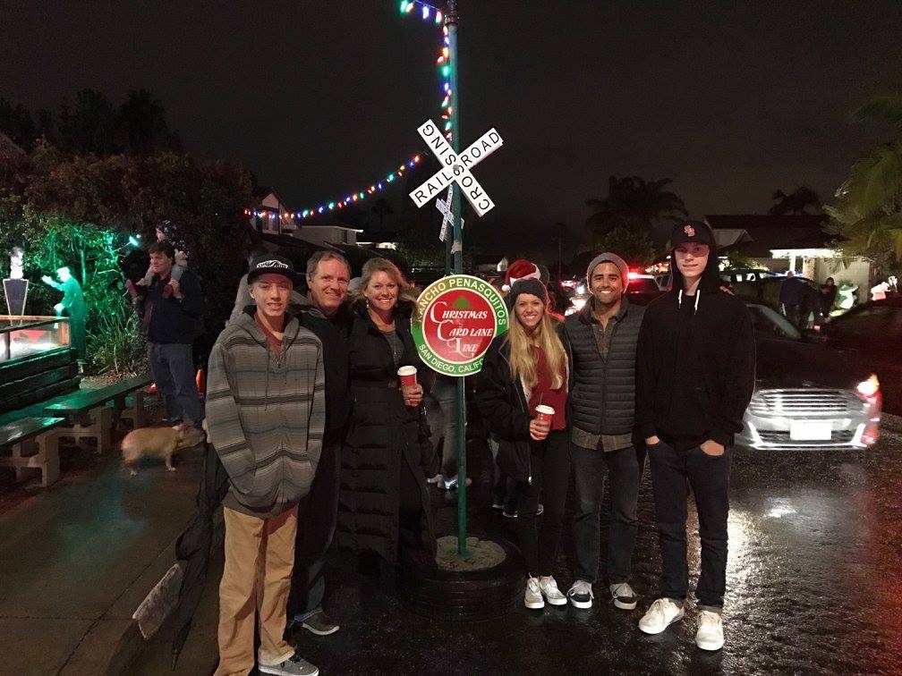 Family visiting the Christmas lights in San Diego at Christmas card lane